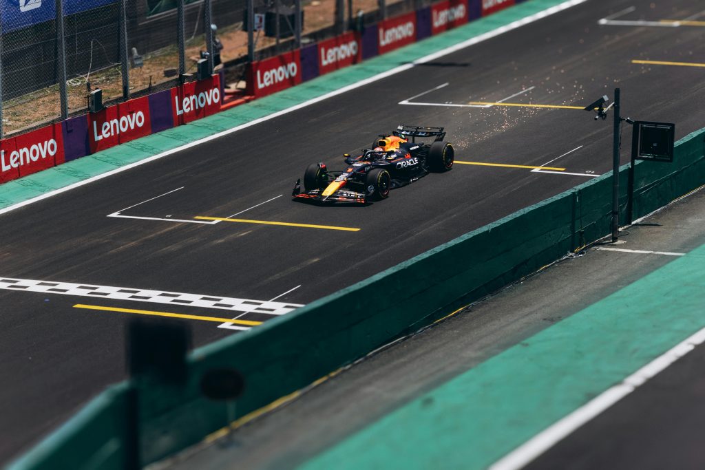 A Formula 1 car speeds down the track during a race, showcasing high performance.